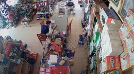 Ceiling panel plunges onto warehouse worker sitting at table