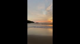 Golden sunset covers beach in West Java, Indonesia