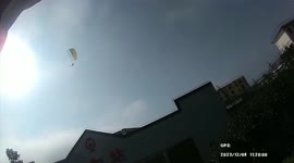 Police stop man flying powered paraglider over railway in China
