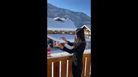 Woman makes Christmas slushie with ice and red syrup in Austria