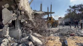 Civil defense teams and residents conduct a search and rescue operation among the destroyed buildings after Israeli attacks in Deir Al Balah, Gaza.