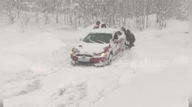 Police Officers Push Stranded Vehicle from Snowdrift in TashTagol District, Russia