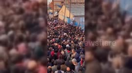 People gather in front of the UNRWA headquarters in Deir Al-Balah, Gaza