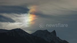 Spectacular bright colourful Sundog , atmospheric phenomenon, seen in the swiss Alps (4K)