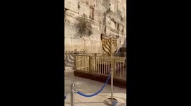 Israelis mark first night of Hanukkah with 138 candles under the Western Wall for missing hostages