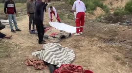 Paramedics collect dead bodies in Deir al-Balah, Gaza