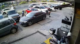 Scooter rider hits drain and goes head over handlebars