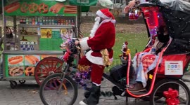 Spread Holiday Joy: Santa Claus Spreads Cheer as Tricycle Rider at Central Park, NY