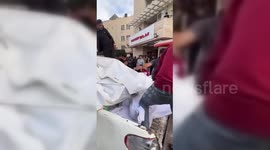 Over 20 bodies are carried on a Pickup truck for burial in Deir al Balah