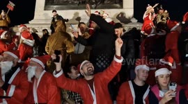 Boozed-up Santas sing and drink in London's Trafalgar Square