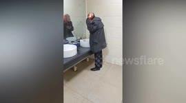 Chinese man seen styling his hair with a lighter