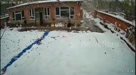 Injured man slips on icy ground while strolling with crutches in China
