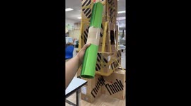 Office workers build Christmas tree with old boxes and coloured papers