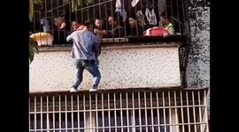 Heroic 'Spider-Man' climbs three floors to save girl dangling from window in China
