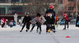 Students enjoy skating on ice-covered ground at school in northeastern China