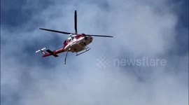 Firefighters Swiftly Tackle Blaze with Aerial Water Assault in Orange County, USA