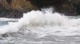 UK Weather, Stormy seas persist and temperatures drop towards zero, but body boarders continue against the cold ocean Towan beach, Newquay, Cornwall UK