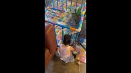 Scared toddler with her head stuck in playpen rescued by mother