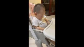 Toddler adorably strokes his pot belly while eating