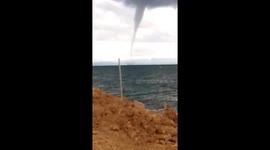 Waterspout tornado reaches down from clouds in the Philippines