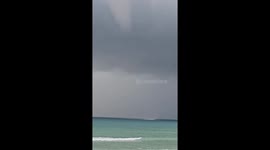 Huge waterspout tornado swirls in front of Thai beach