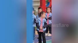 Girl sneezes and has hands mistakenly rubbed together by teacher