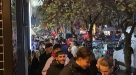 Hundreds queue round the block for free burgers outside fast food store in Greece