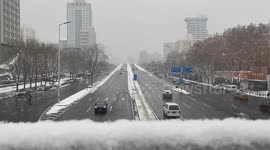 Vehicles Drive in Snow in Beijing, China