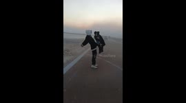 Battling the Elements: Three Men Lean Against Strong Winds to Avoid Falling Down in Northern China