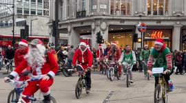 Hundreds of Santas ride through London's  Oxford Circus