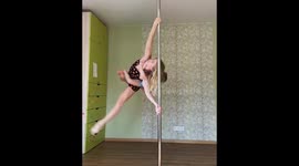 Mother demonstrates incredible strength as she pole dances with 7-year-old son on back