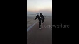 China: Three Men Lean Against Strong Winds Without Falling In Yuncheng, Shanxi