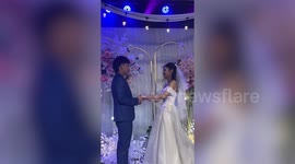 Bride trips over on wedding reception with groom