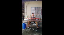 Christmas spirits! Boy plays carols on wine glass xylophone with plastic container for drum