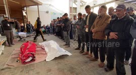 People attend the funeral prayer for Palestinians, who died in the Israeli airstrikes mourning ahead of the funeral ceremony at the Hospital in Rafah.