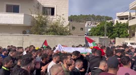 Mourners carry the body of Palestinian youth Atallah Badah, 16, who died of injuries sustained in a reported Israeli raid a day earlier during his funeral at his village of Deir Amar east of Ramallah