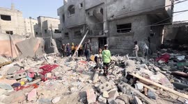 Palestinians searche in the ruins of a building in the aftermath of an overnight Israeli bombing in Nuseirat in the Central Gaza Strip.