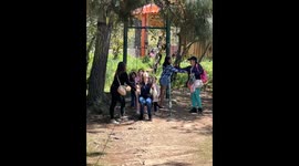 Unaware woman takes a surprise flying knee from ziplining kid