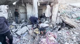 Palestinians search through rubble following strikes on Gaza's Deir al-Balah