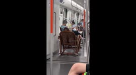 Pensioner takes wooden rocking chair onto subway train in China