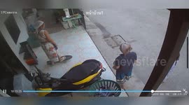 Grandmother rolling on skateboard slips and falls on floor
