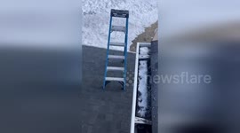 Step ladder traps man on roof after 'walking' away on its own due to heavy wind