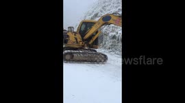 Tourists flee as out-of-control excavator skids down icy road in China