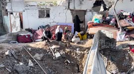 Residents inspect around the rubble of the building following an Israeli attack in Dair El-Balah, Gaza.
