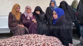 People attend the funeral prayer for Palestinians, who died in the Israeli airstrikes mourn ahead of the funeral ceremony at the Hospital in Rafah.