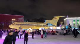 Beautiful old-fashined Russian plane in Christmas lights set near Ice-skating ring at VDNKH exhibition park in Moscow,  Russia