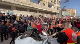 Palestinians inspect the site of an Israeli strike on a car, amid the ongoing conflict between Israel and the Palestinian Islamist group Hamas, in Rafah, southern Gaza Strip.