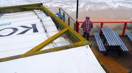 UK Weather Christmas Eve. Gales and rain dampen spirits for Christmas visitors well wrapped up on Fistral beach, Newquay, Cornwall, UK
