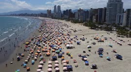 Tourists enjoy the very hot day on Christmas Eve at the beach in Sao Paulo, Brazil