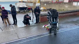 Flowers and note left at entrance to Portland Port, UK after Bibby Stockholm death